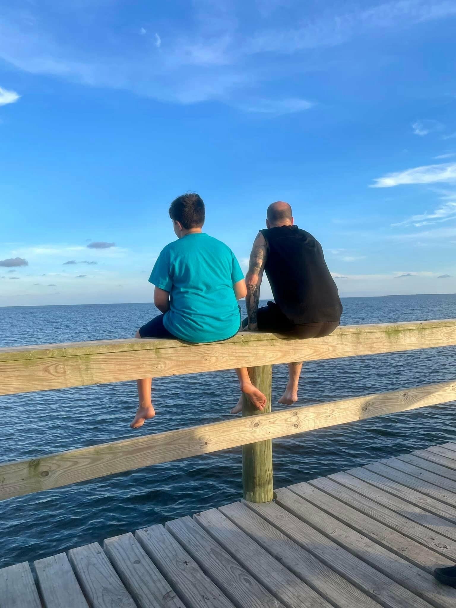 Ryan Light, life coach sitting with his son in Flordia Coast
