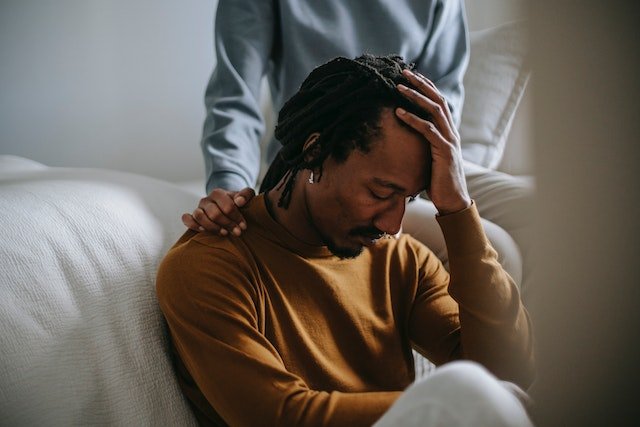 Man sitting in grief struggling with Borderline Personality Disorder.