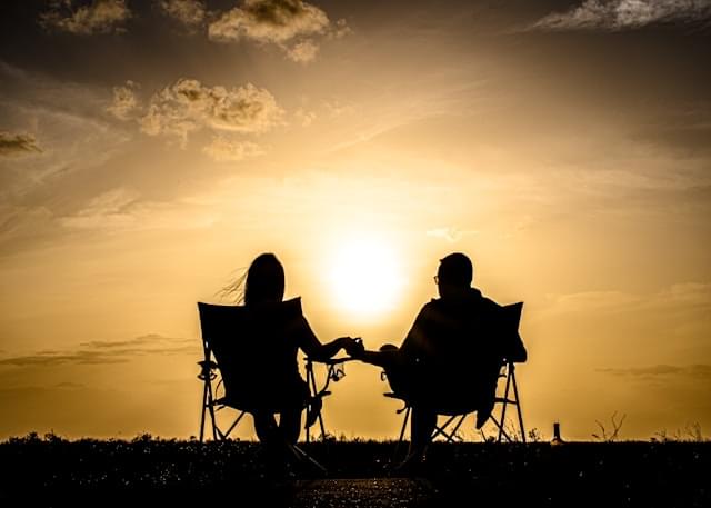 couple sitting watching the sunset dealing with chronic illness